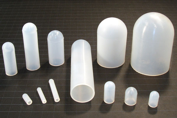 An array of straight wall silicone caps for masking threaded studs during metal finishing