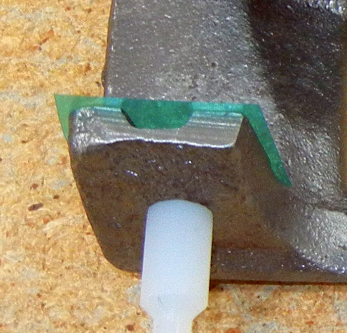 Close up of masked brake caliper before powder coating